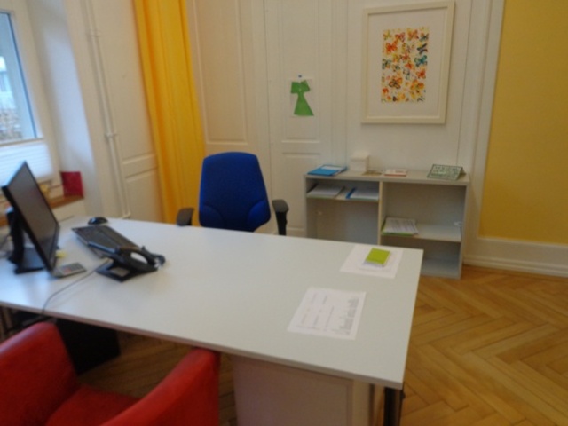 Office table with two chairs, computer screen and desk